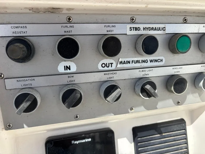Slide: The Image of Control panel of a 1994 Nautor Swan 46 MK II sailboat, featuring various switches and dials. - 23