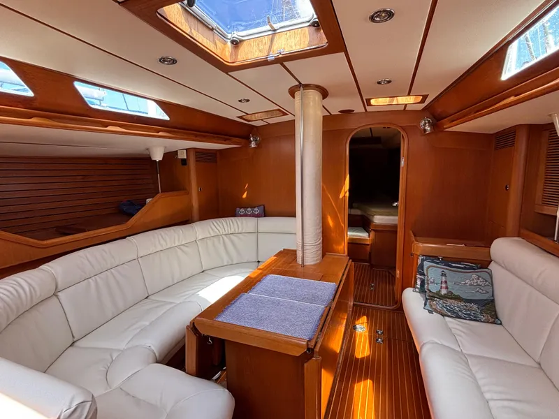 Slide: The Image of Luxurious interior of 1994 Nautor Swan 46 MK II yacht with white seating and wooden finishes. - 25