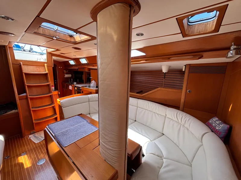 Slide: The Image of Luxurious interior of 1994 Nautor Swan 46 MK II yacht with elegant wood and white seating. - 26