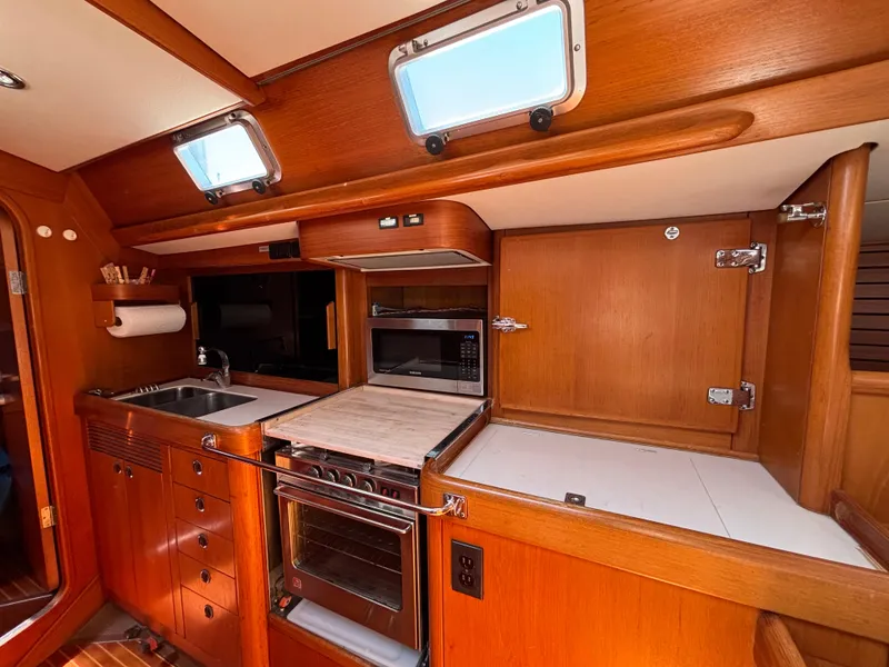 Slide: The Image of Interior of 1994 Nautor Swan 46 MK II yacht kitchen with wood cabinetry and appliances. - 29