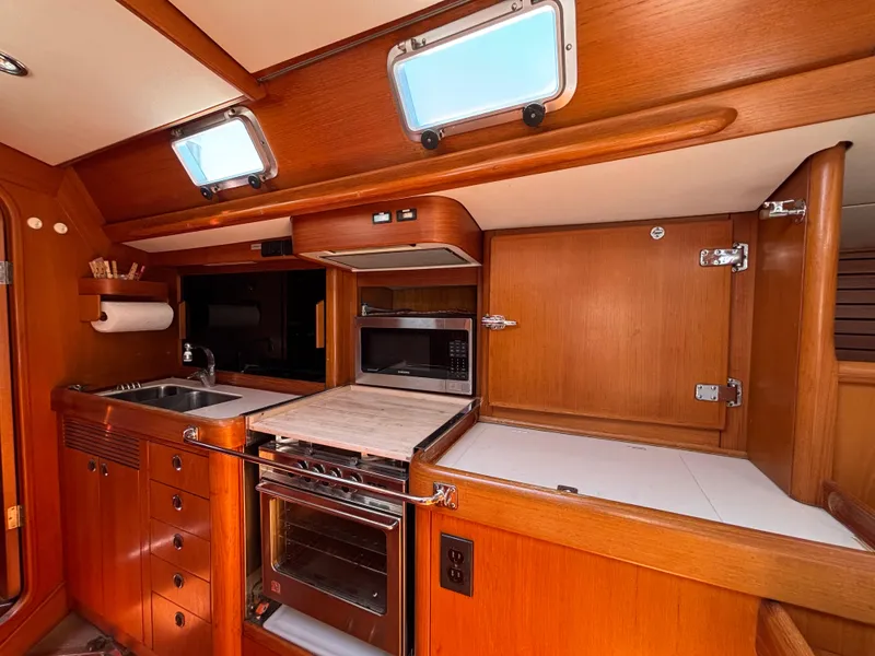 Slide: The Image of Nautor Swan 46 MK II 1994 yacht kitchen with wood cabinetry, oven, and sink. - 30