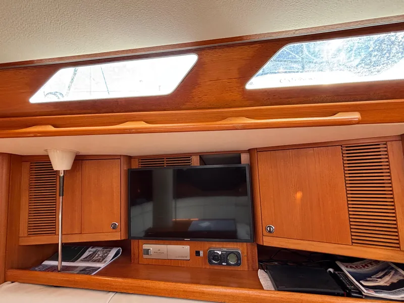 Slide: The Image of Interior of 1994 Nautor Swan 46 MK II yacht with wooden cabinets and a TV. - 31