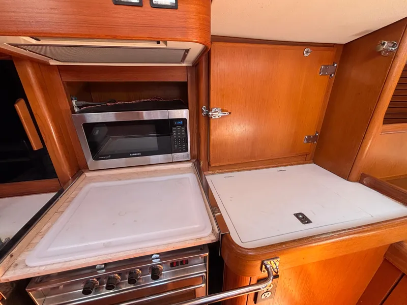 Slide: The Image of Interior of 1994 Nautor Swan 46 MK II yacht kitchen with microwave and stove. - 32