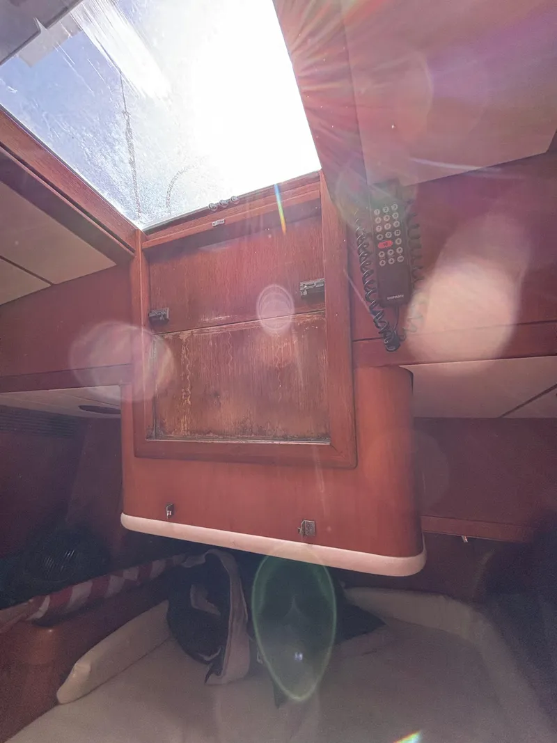 Slide: The Image of Interior view of 1994 Nautor Swan 46 MK II sailboat with sunlight streaming through hatch. - 42