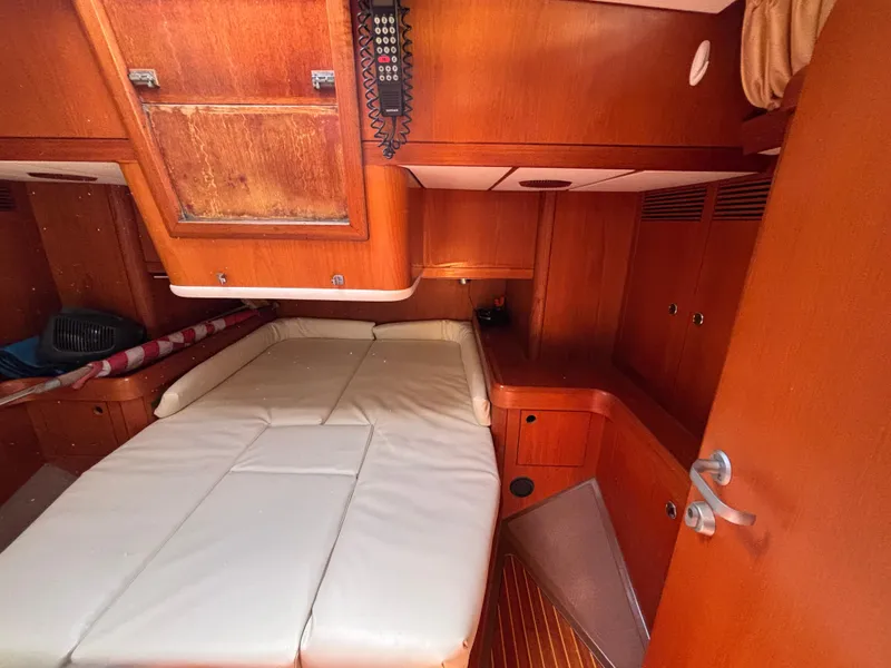 Slide: The Image of Interior cabin of 1994 Nautor Swan 46 MK II yacht with wooden finish and white bedding. - 43