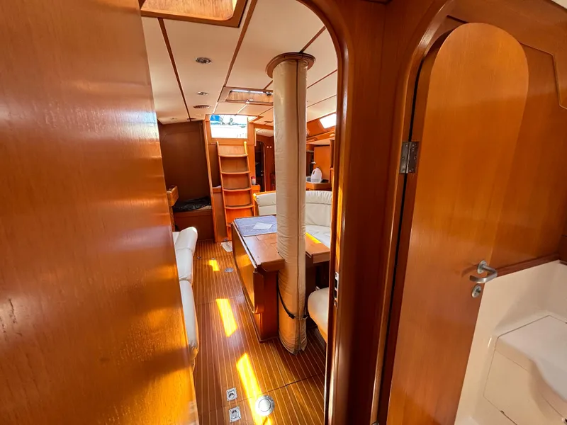 Slide: The Image of Interior of 1994 Nautor Swan 46 MK II yacht, featuring wooden finishes and cozy seating. - 46