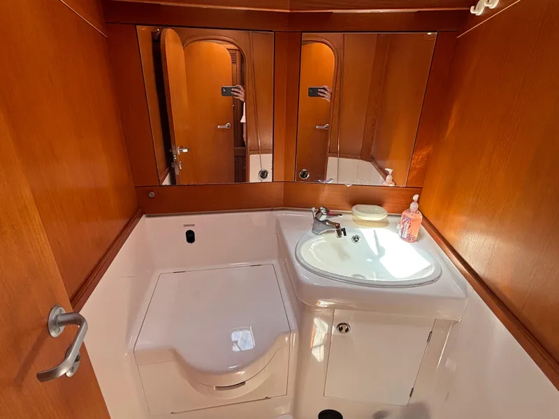 Slide: The Image of Elegant bathroom in 1994 Nautor Swan 46 MK II yacht with wooden cabinetry and modern fixtures. - 47