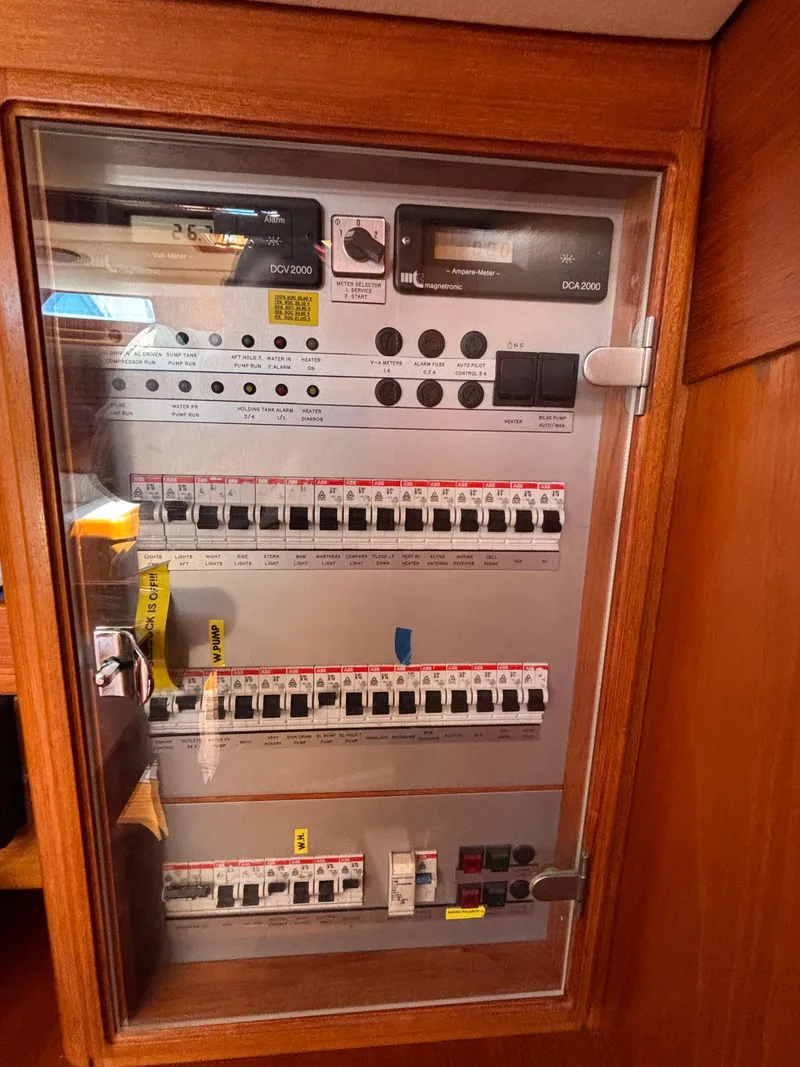 Slide: The Image of Electrical panel inside a 1994 Nautor Swan 46 MK II yacht, featuring multiple switches and controls. - 48