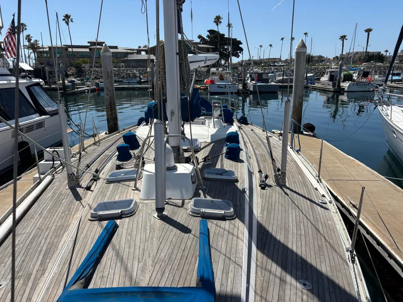 Slide: The Image of Sailboat Nautor Swan 46 MK II, 1994, docked in a marina with clear skies. - 5