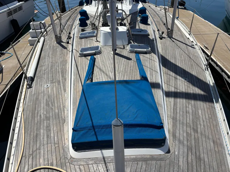 Slide: The Image of Deck of 1994 Nautor Swan 46 MK II sailboat with blue covers and wooden finish. - 6