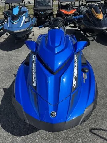 Slide: The Image of 2023 Yamaha WaveRunner GP1800R in vibrant blue, parked among other jet skis. - 3