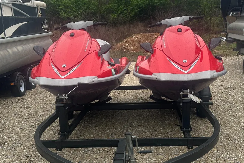 Slide: The Image of Two red 2006 Yamaha WaveRunner VX 110 Deluxe jet skis on a trailer. - 1