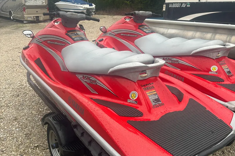 Slide: The Image of 2006 Yamaha WaveRunner VX 110 Deluxe, red, parked on gravel, side view. - 12