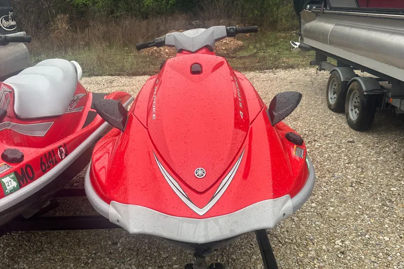 Slide: The Image of 2006 Yamaha WaveRunner VX 110 Deluxe, red, parked on gravel near trailer. - 5