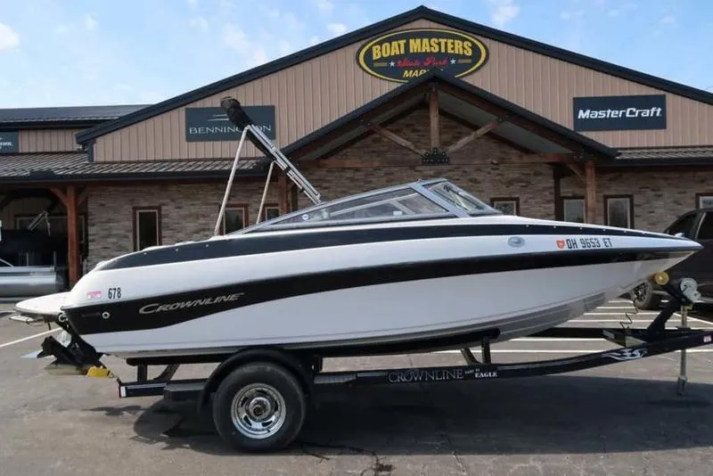 Slide: The Image of 2011 Crownline 18 SS boat on trailer at dealership, Boat Masters sign in background. - 1