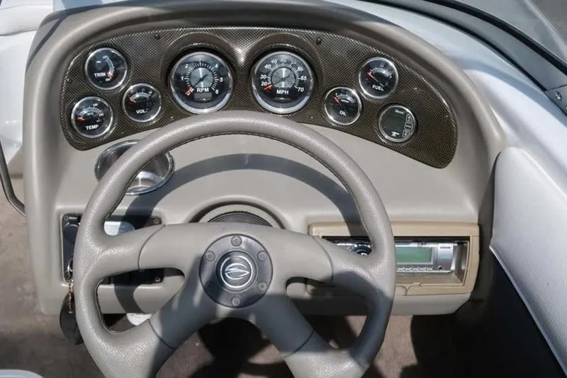 Slide: The Image of Dashboard of a 2011 Crownline 18 SS boat with steering wheel and gauges. - 10