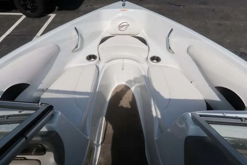 Slide: The Image of 2011 Crownline 18 SS boat interior with white seating and cup holders. - 12