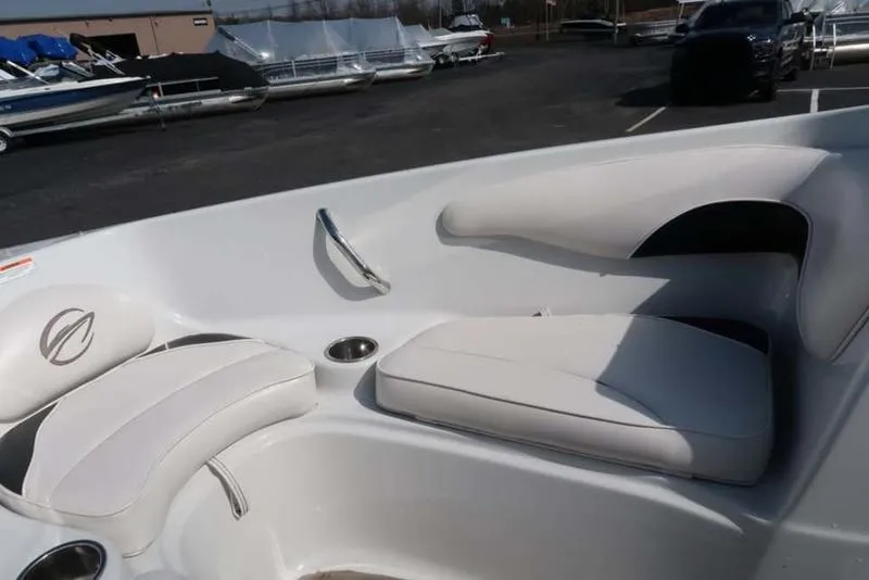 Slide: The Image of Interior seating of a 2011 Crownline 18 SS boat, featuring white cushioned seats. - 5