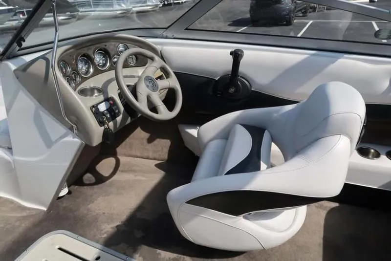 Slide: The Image of Interior of a 2011 Crownline 18 SS boat with steering wheel and captain's chair. - 7