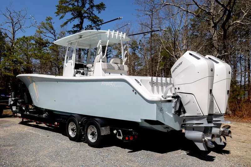 Slide: The Image of 2023 Front Runner 33 Center Console boat with dual engines on a trailer. - 2