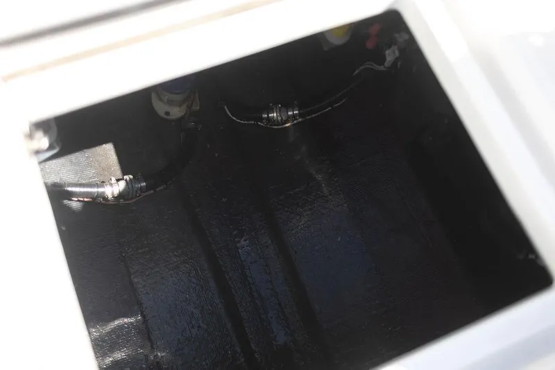 Slide: The Image of 2023 Front Runner 33 Center Console storage compartment with visible wiring and components. - 24