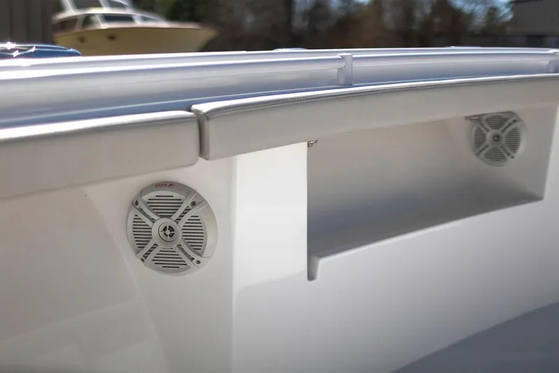 Slide: The Image of 2023 Front Runner 33 Center Console boat speakers and storage compartment detail. - 27