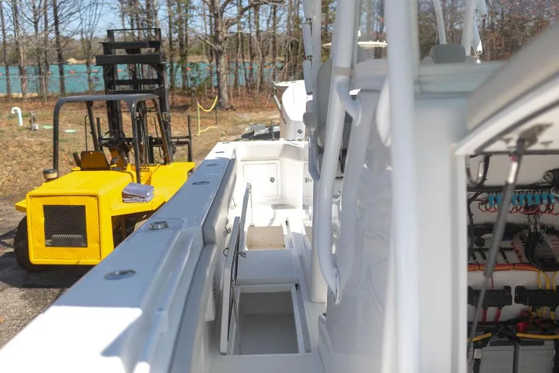 Slide: The Image of 2023 Front Runner 33 Center Console boat with visible interior and nearby yellow forklift. - 31