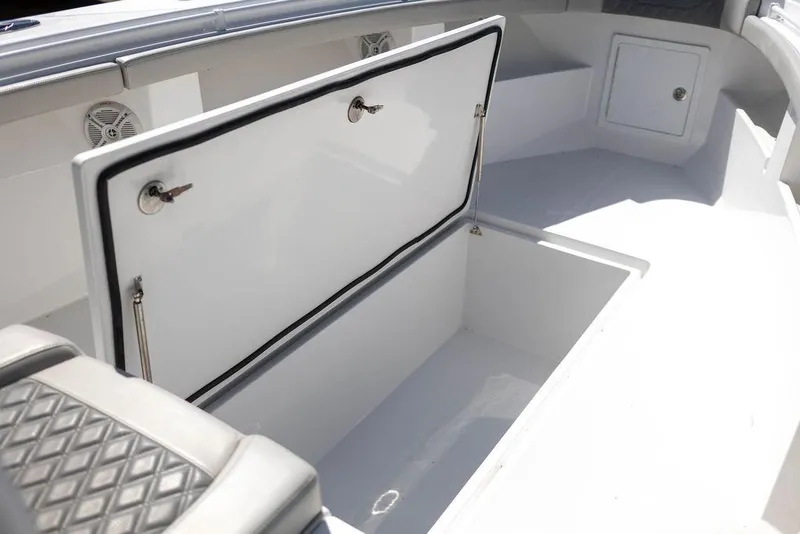 Slide: The Image of 2023 Front Runner 33 Center Console boat storage compartment open, showcasing spacious interior. - 32