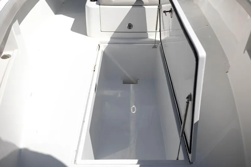 Slide: The Image of 2023 Front Runner 33 Center Console boat storage compartment open. - 33