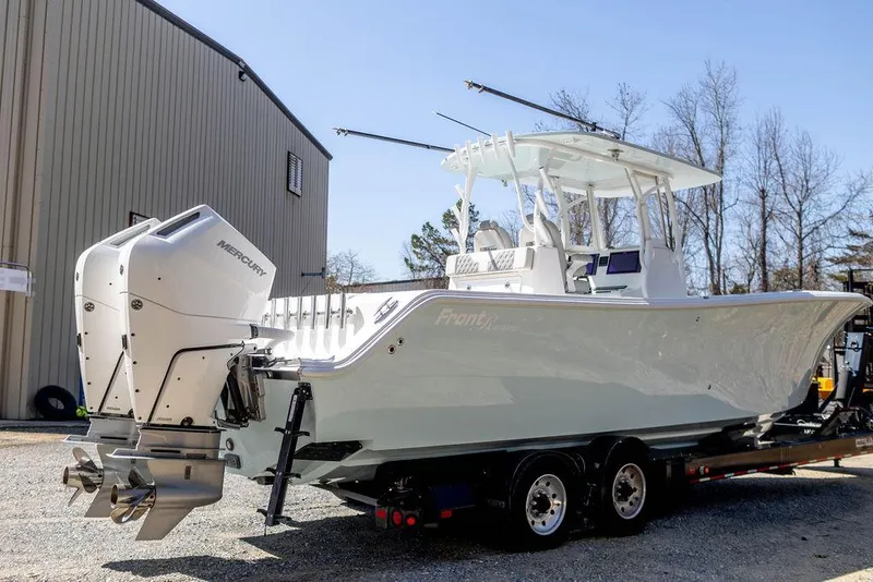 Slide: The Image of 2023 Front Runner 33 Center Console boat on trailer, outdoor setting. - 4