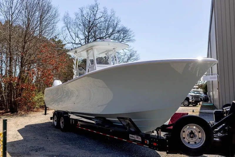 Slide: The Image of 2023 Front Runner 33 Center Console boat on trailer, parked outdoors. - 5