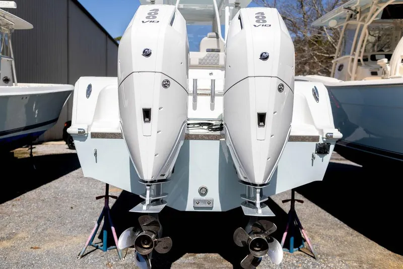 Slide: The Image of 2023 Front Runner 33 Center Console with dual outboard engines, displayed outdoors. - 7