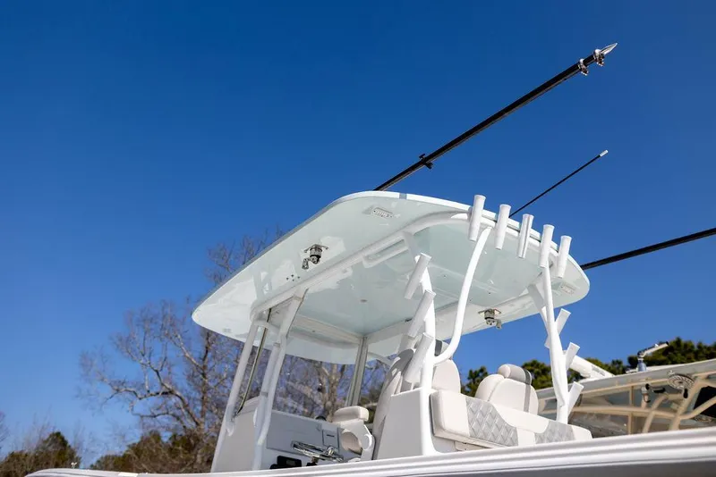 Slide: The Image of 2023 Front Runner 33 Center Console boat with fishing rods against clear blue sky. - 8