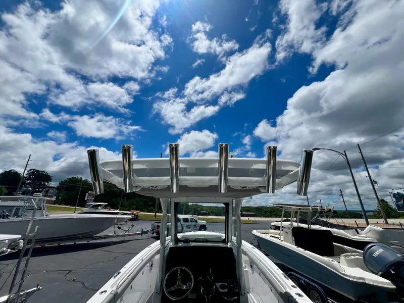 Slide: The Image of 2024 Everglades 285 Center Console boat under a bright blue sky with clouds. - 14
