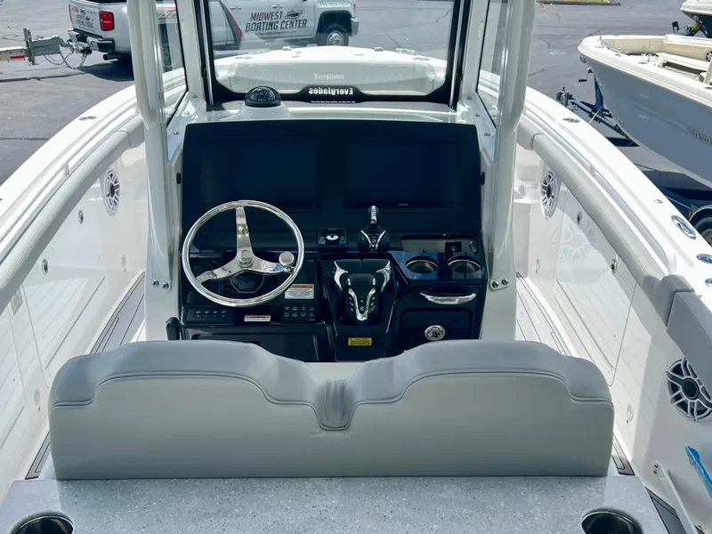 Slide: The Image of 2024 Everglades 285 Center Console boat interior with steering wheel and control panel. - 17