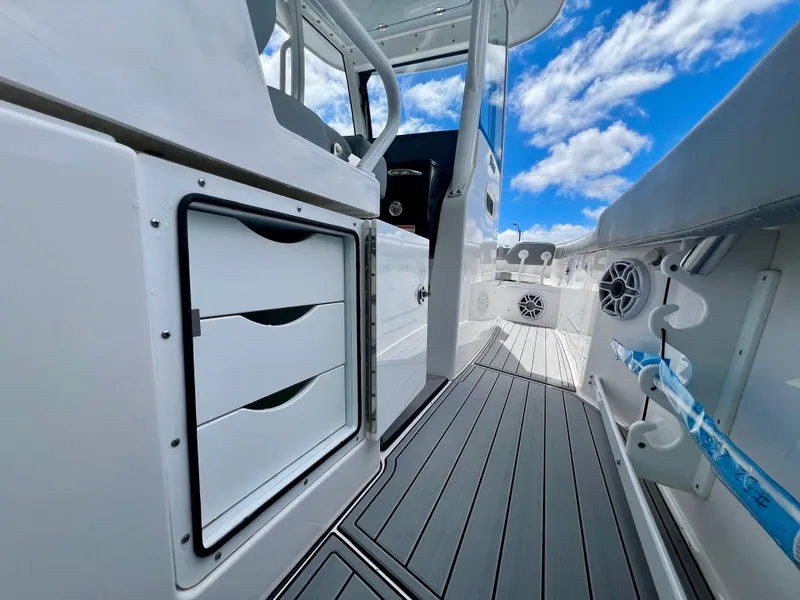 Slide: The Image of 2024 Everglades 285 Center Console boat interior with storage drawers and sleek design. - 22