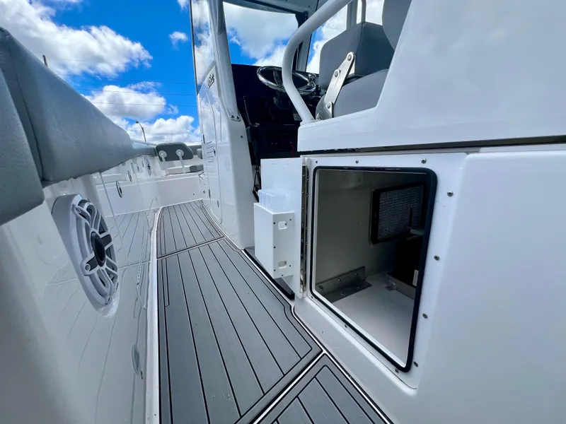 Slide: The Image of 2024 Everglades 285 Center Console boat interior with open storage compartment and sleek design. - 24