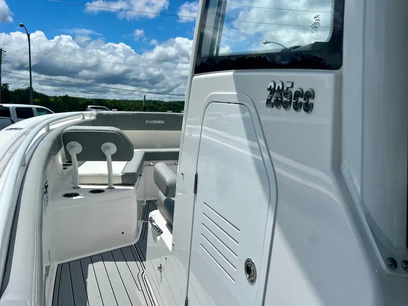 Slide: The Image of 2024 Everglades 285 Center Console boat, sleek design, spacious deck, under clear blue sky. - 26