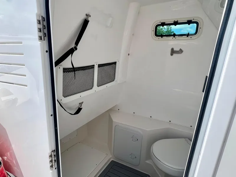 Slide: The Image of 2024 Everglades 285 Center Console boat interior with toilet and storage compartments. - 27