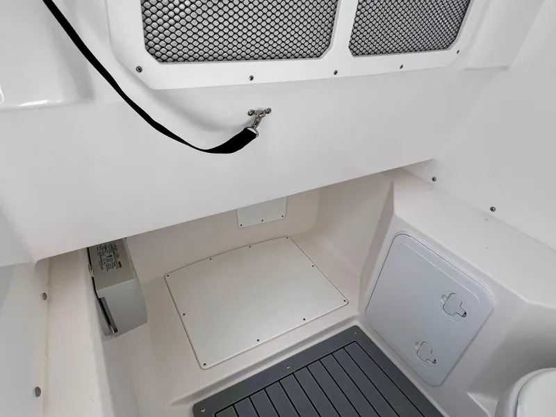 Slide: The Image of 2024 Everglades 285 Center Console interior with storage compartments and netting. - 29