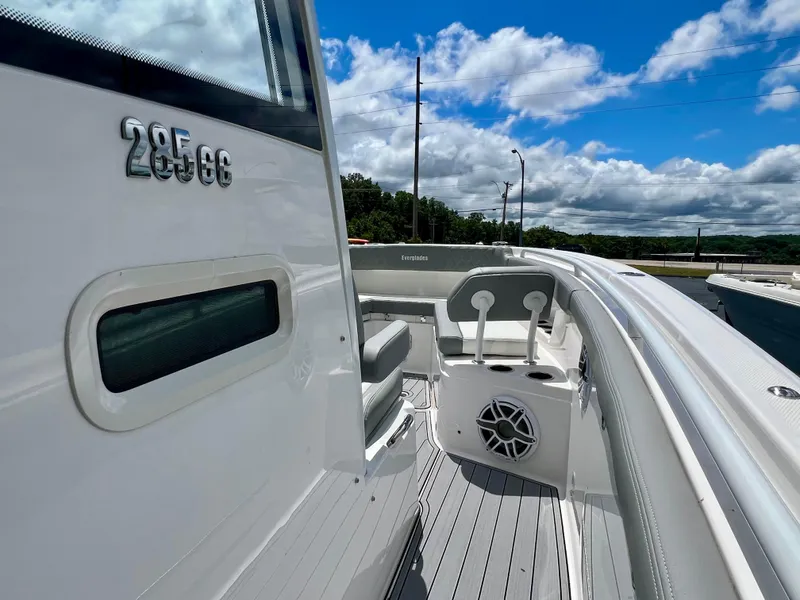 Slide: The Image of 2024 Everglades 285 Center Console boat, sleek design, white exterior, under blue sky. - 30