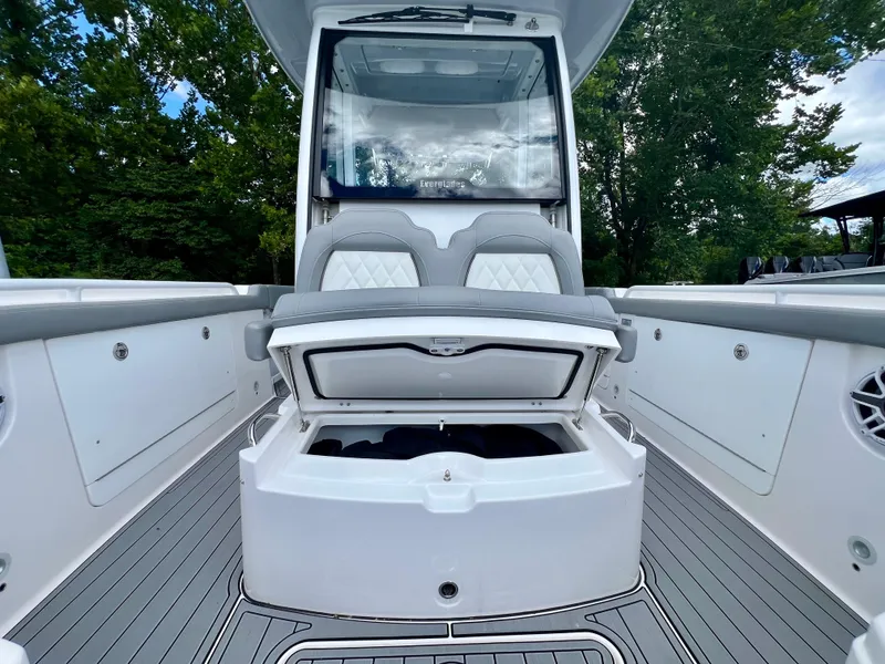 Slide: The Image of 2024 Everglades 285 Center Console boat with open storage compartment and cushioned seating. - 34