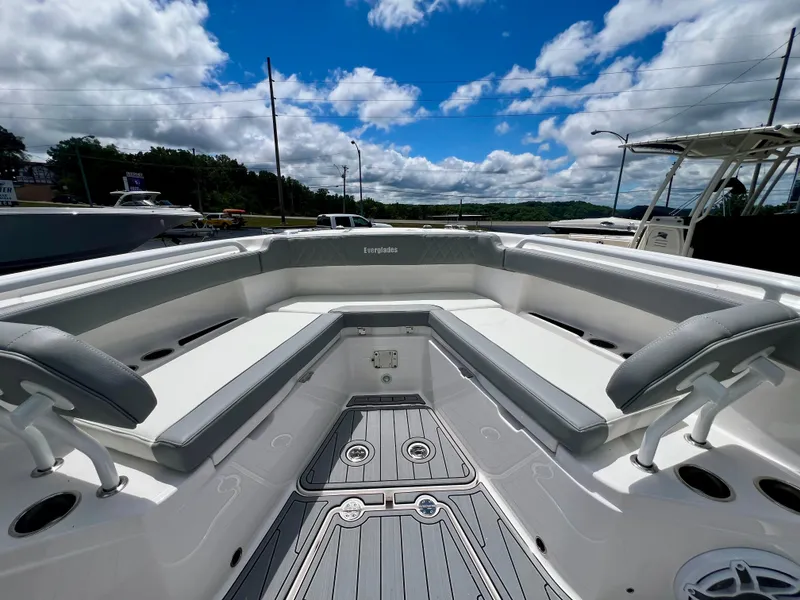 Slide: The Image of 2024 Everglades 285 Center Console boat interior with seating, under a blue sky. - 35