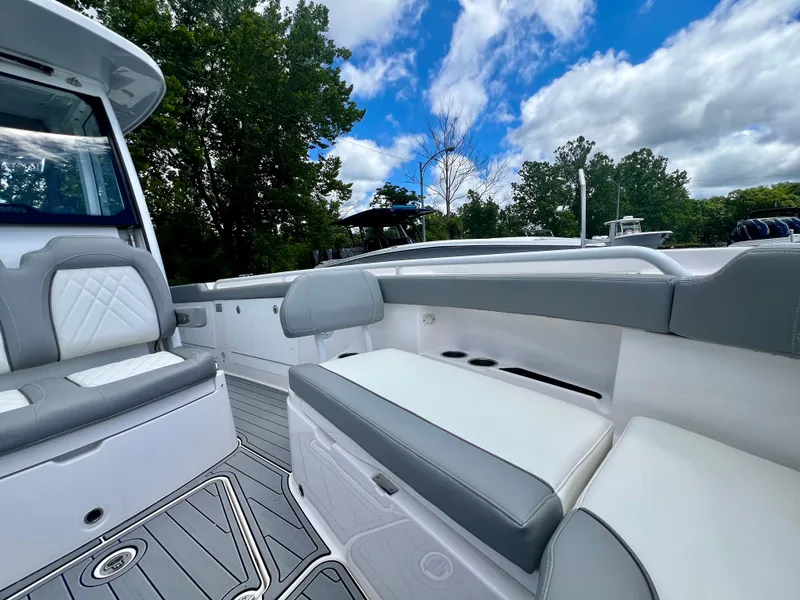 Slide: The Image of 2024 Everglades 285 Center Console boat interior with cushioned seating and sleek design. - 38