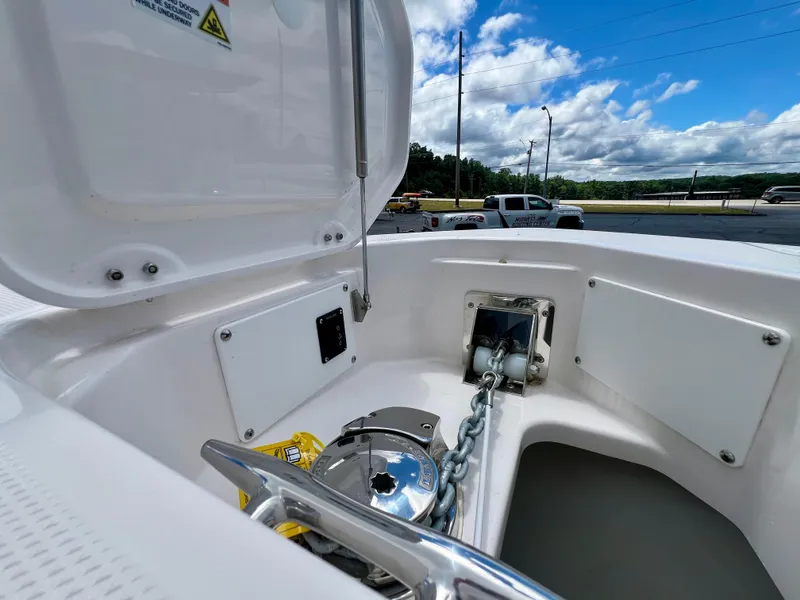 Slide: The Image of 2024 Everglades 285 Center Console anchor compartment with open hatch, showcasing chain and winch. - 41