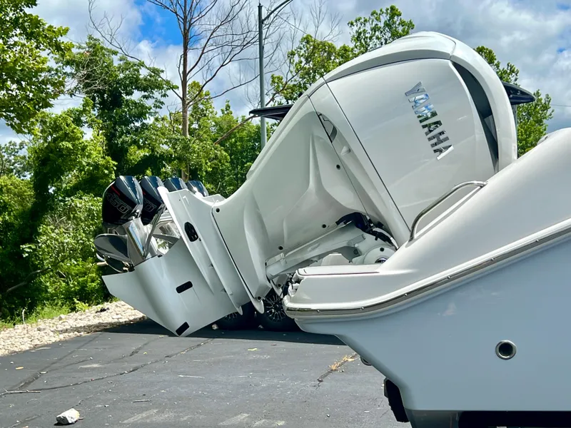 Slide: The Image of 2024 Everglades 285 Center Console boat with Yamaha outboard motor, parked outdoors. - 42