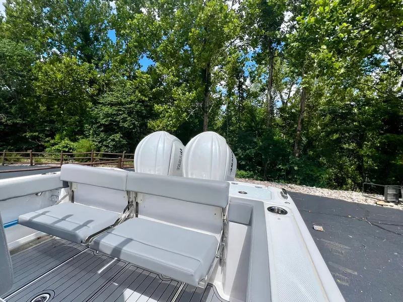 Slide: The Image of 2024 Everglades 285 Center Console boat with dual engines, surrounded by lush greenery. - 8