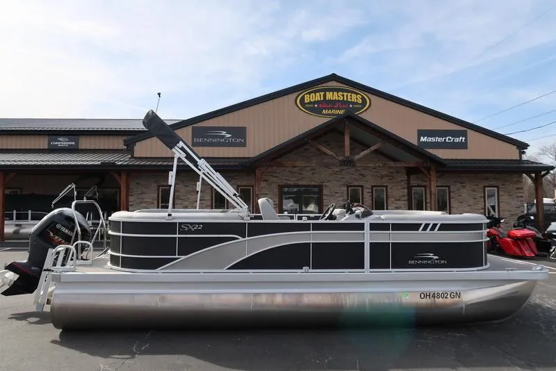 Slide: The Image of 2024 Bennington 22 SXSR pontoon boat parked outside Boat Masters dealership. - 1
