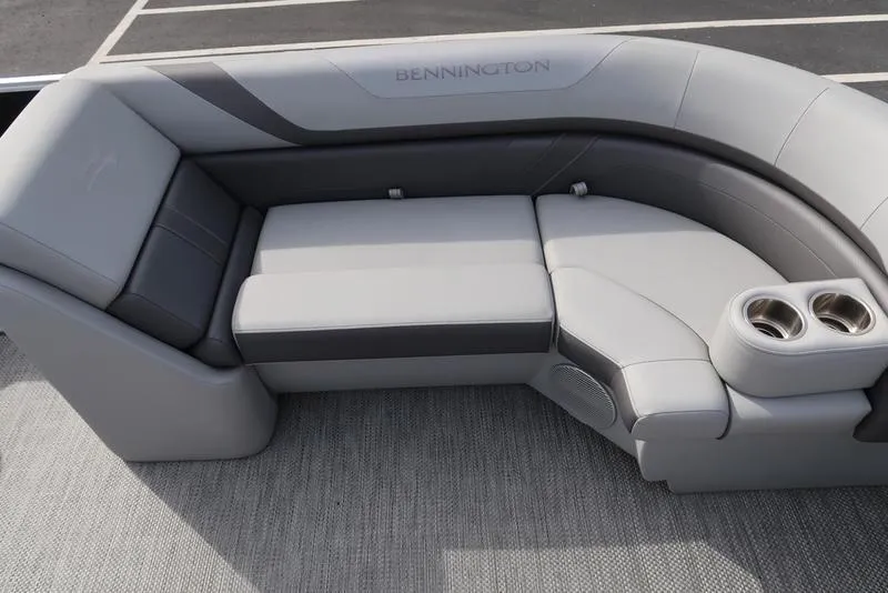 Slide: The Image of 2024 Bennington 22 SXSR boat interior with gray seating and cup holders. - 13
