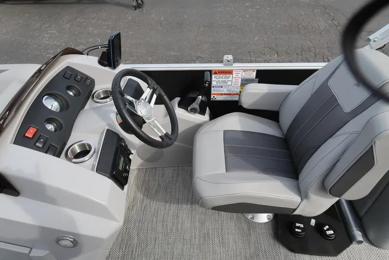 Slide: The Image of 2024 Bennington 22 SXSR boat cockpit with steering wheel and captain's chair. - 15
